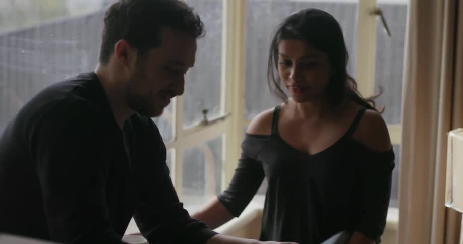 A man and woman unpack boxes