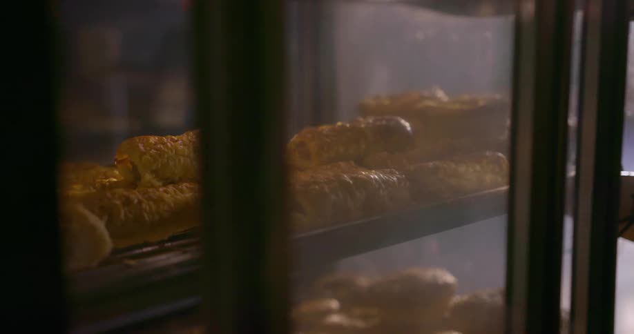 Food is lifted out of a display with tongs