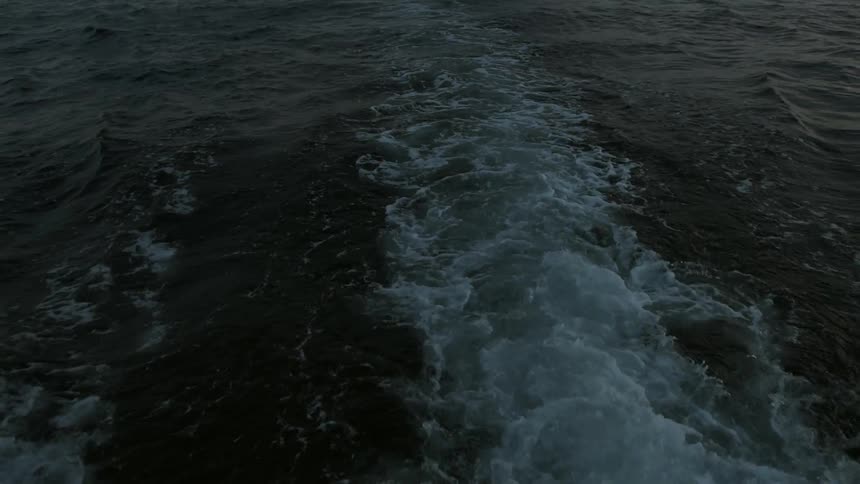 Water bubbles below behind a ship