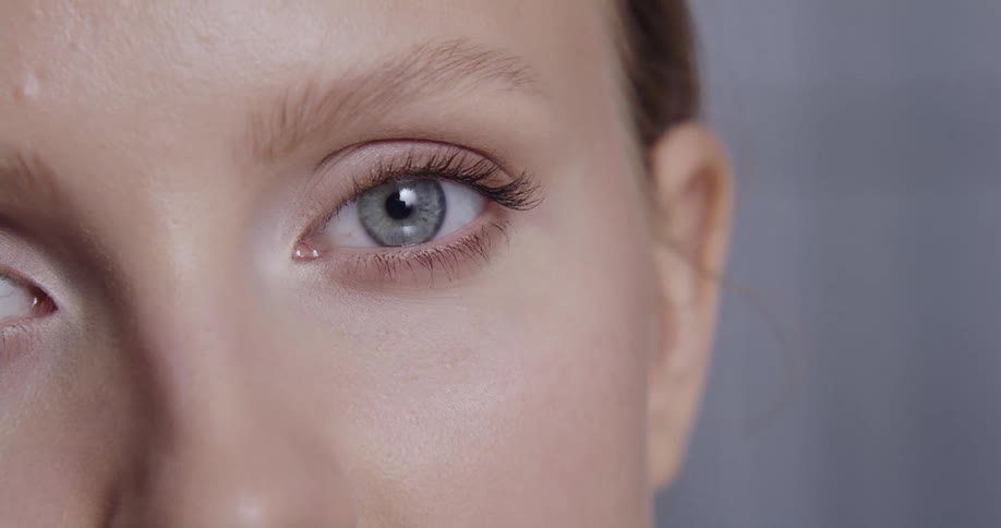 A model touches her nose with her fingers