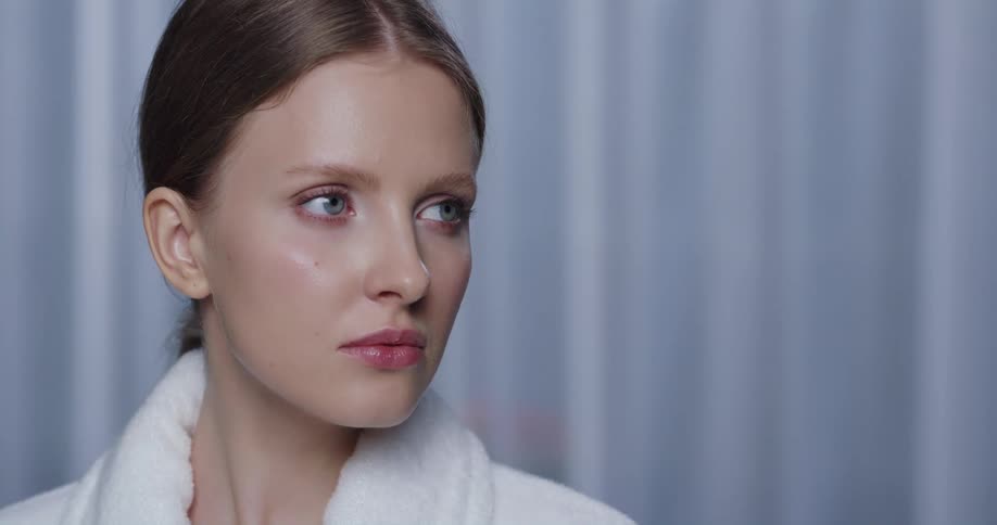 A woman blinks and moves her head around