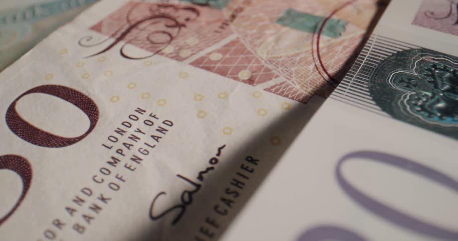 A pile of money sits spread out on a table