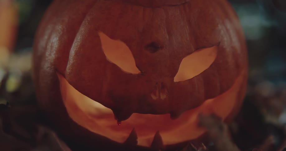 Ajack olantern is lit up and smoke is coming from inside it