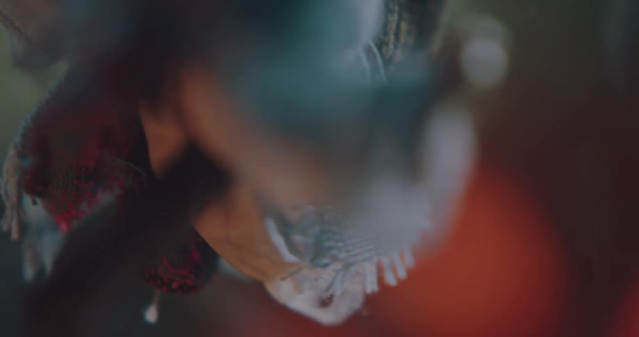 A bundle of fabric spins over rising smoke