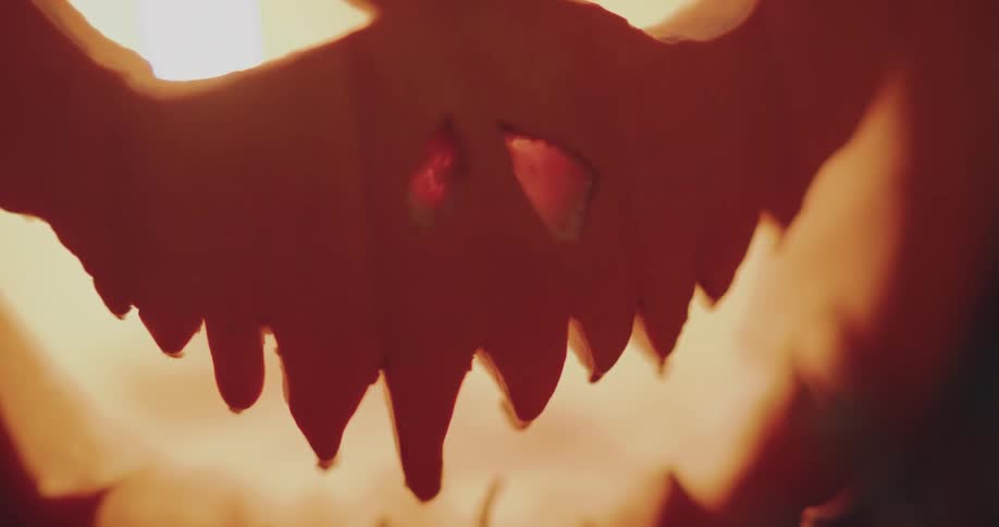 A candle glows inside a jack o lantern