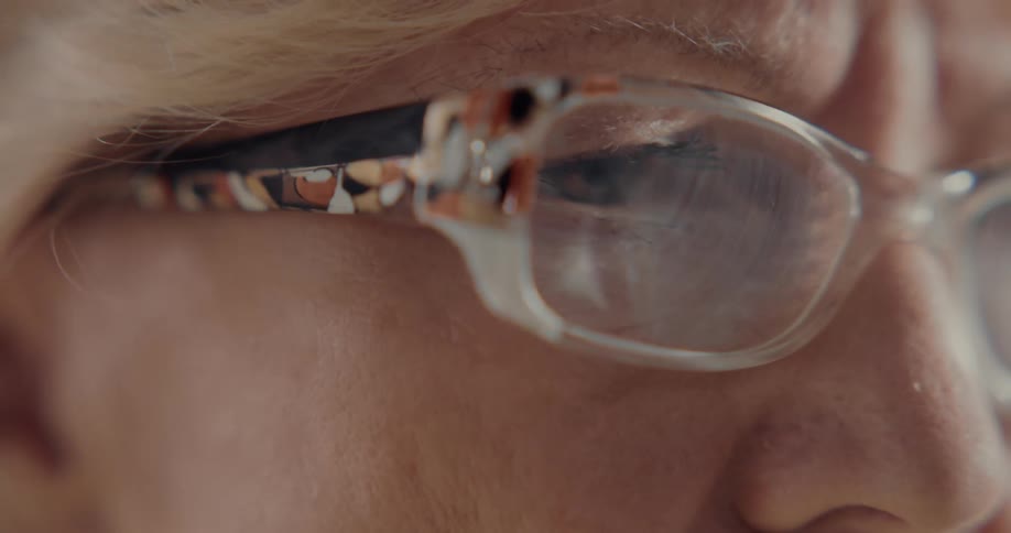 A view of a woman with glasses