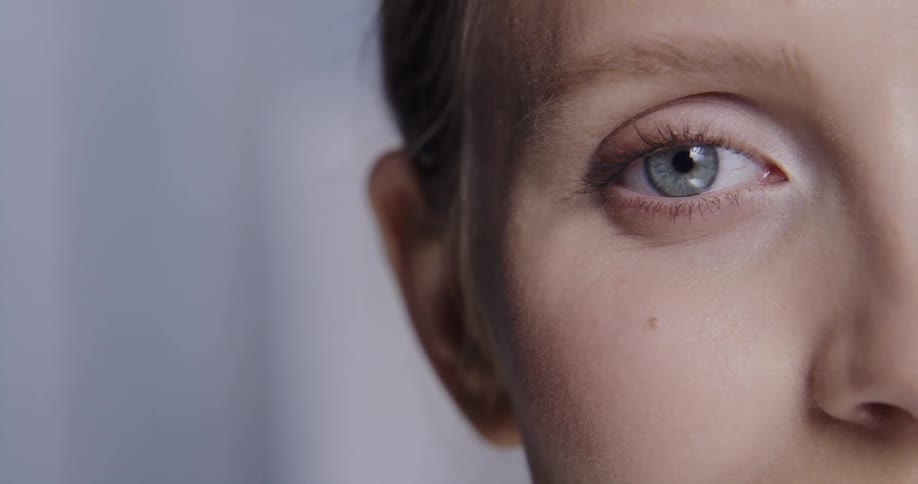 Close up view of a womans face is displayed with makeup