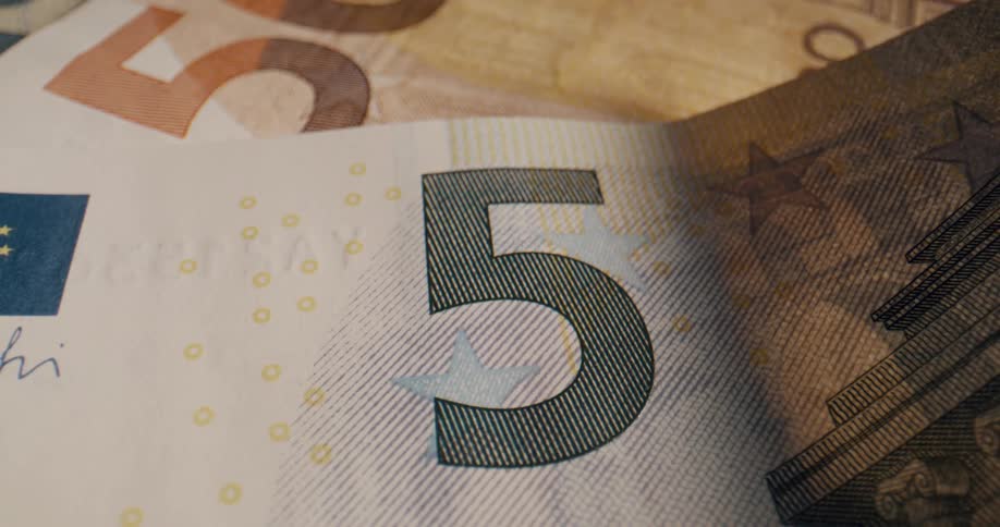 Fifty and five currency notes are laying down