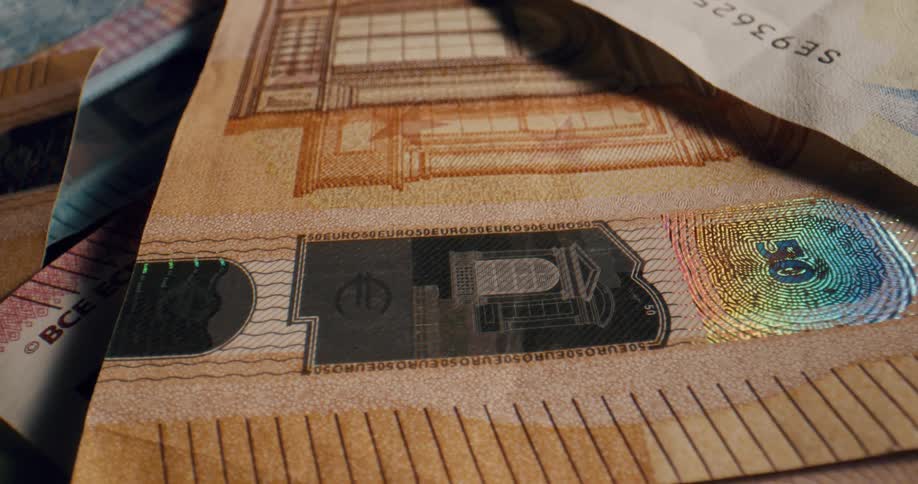 A pile of colorful banknotes on a flat surface