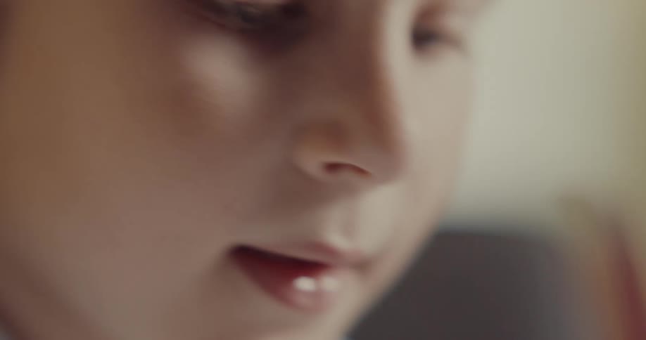 A child is writing with a pencil
