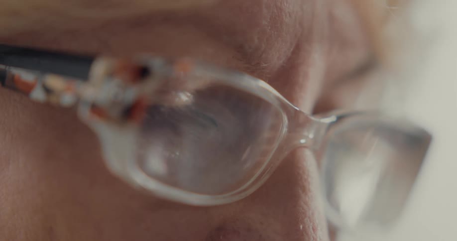 A close up view of an elderly woman with glasses on