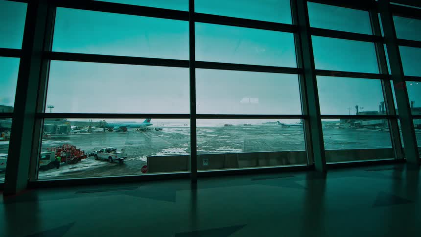 Time lapse of an airport hall with a view of the runway