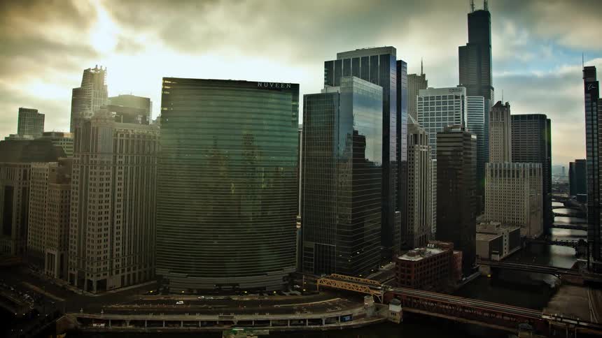 Clouds pass over tall city buildings