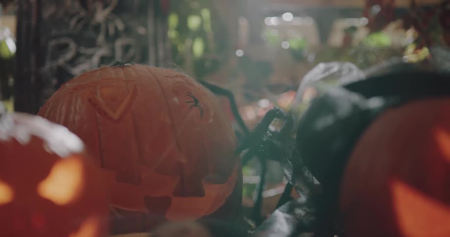 Plastic halloween pumpkin and tombstone decorations under a soft light
