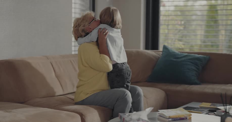 Grandmother and grandson are hugging and happy