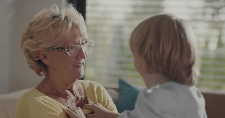 Older woman is playing with the child inside