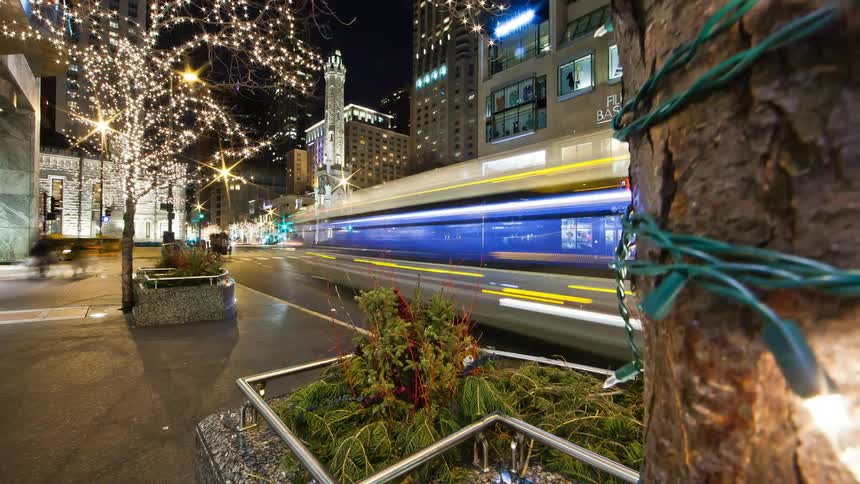 Time lapse of vehicles and pedestrians in a city at night