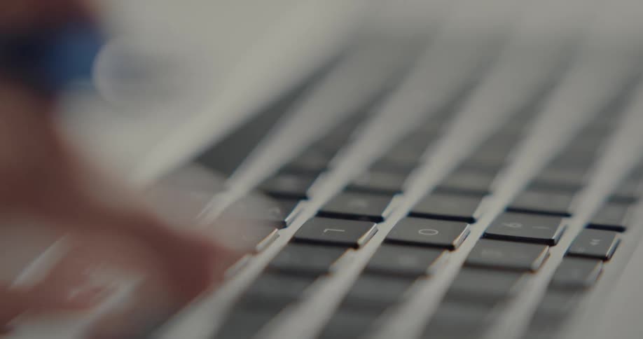 A woman typing on a laptop