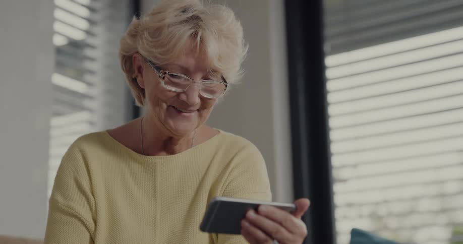 A woman is video chatting with someone on her cell phone