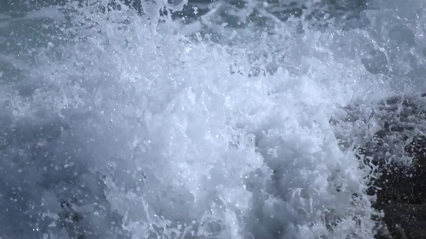 Waves crash on rocks below