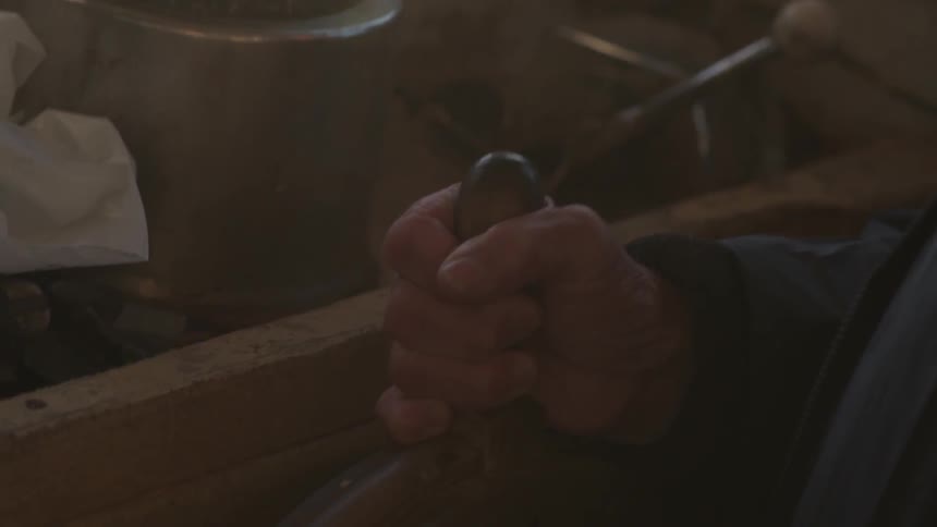 Close up of a hand on ship's helm