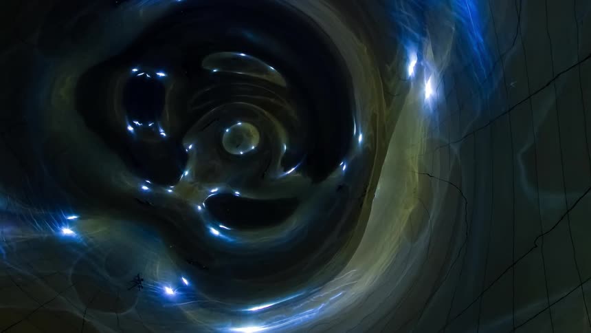 Debris flies through a shiny and metallic object