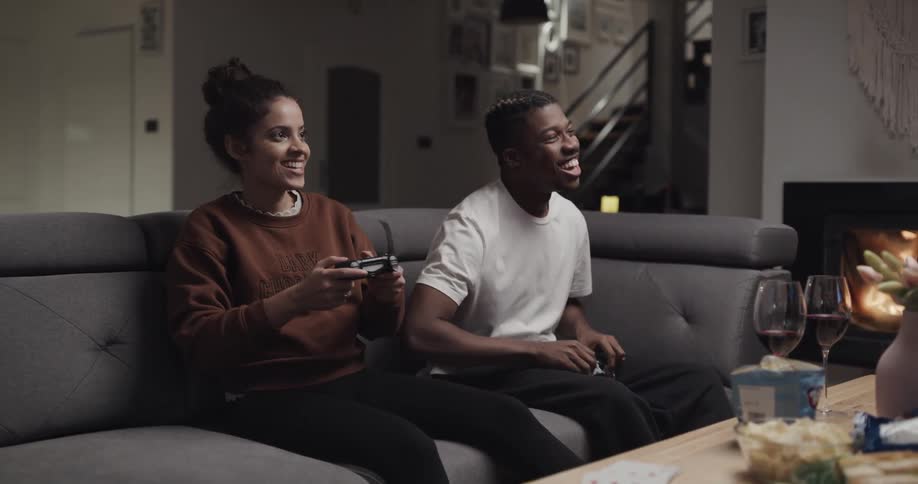 Young man and woman are playing video games together