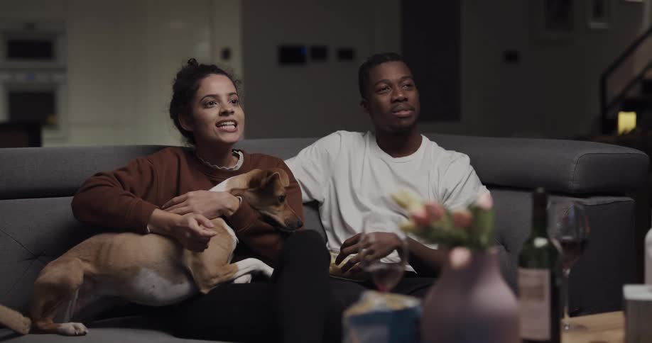 A man or woman are chilling and hanging out with a dog