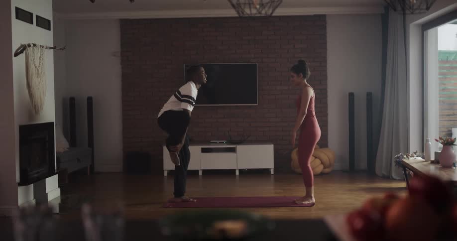 A man and woman perform yoga together