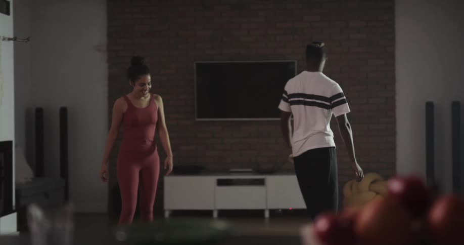 Young couple practice dance moves on the living room at home