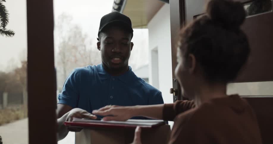 A man delivering a package to a woman