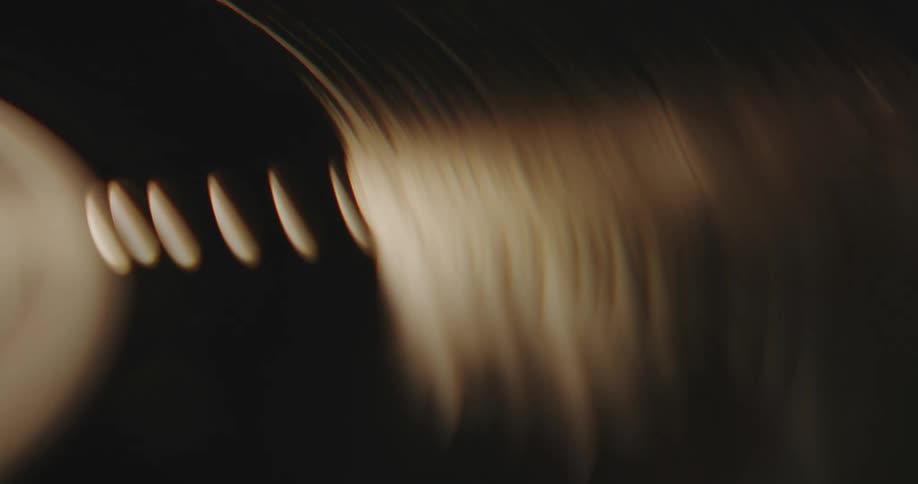 A blurry block separates into sharp shapes as they move down a tube like surface