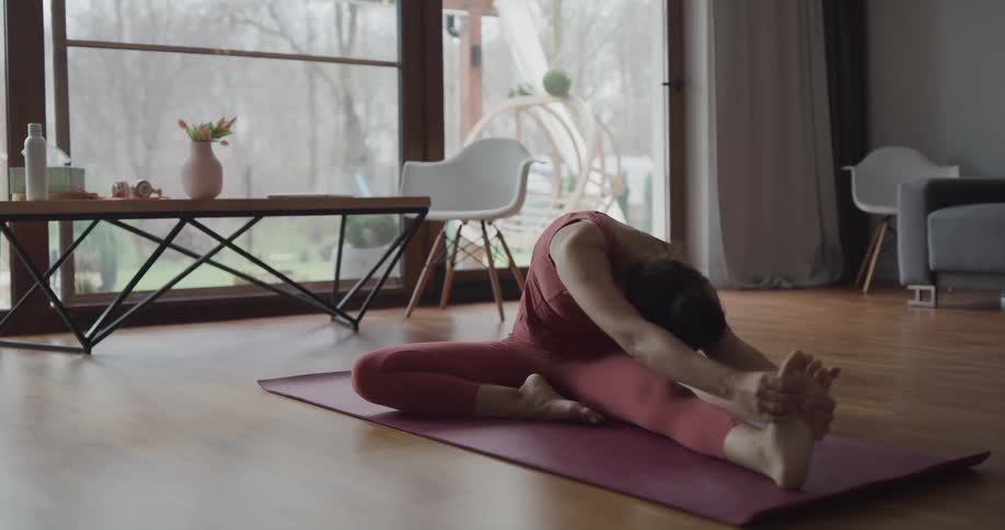 A dog runs past a woman doing yoga