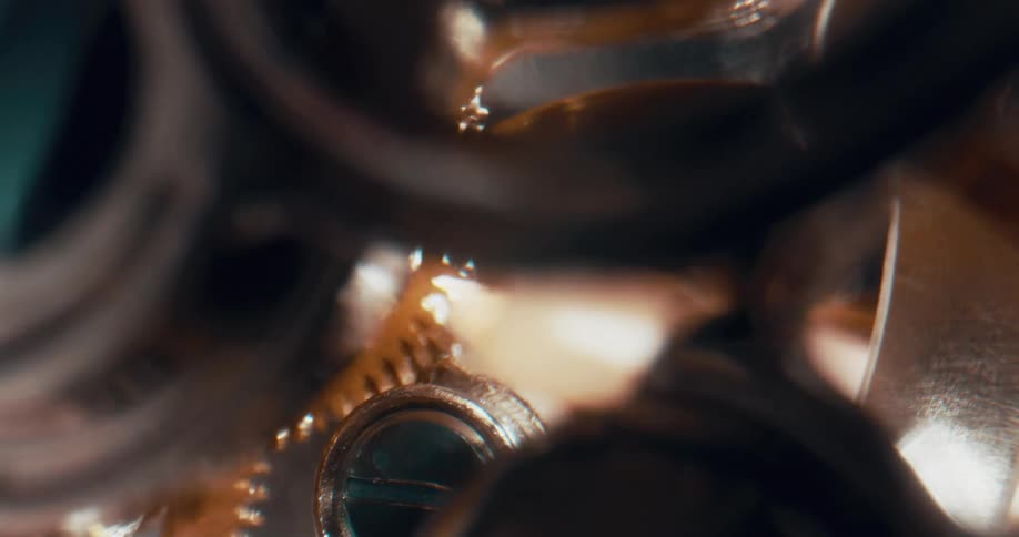 Gears spin and flicker inside an analog watch