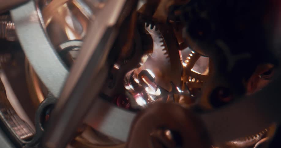 Lights flash as gears and wheels inside a mechanism turn and move