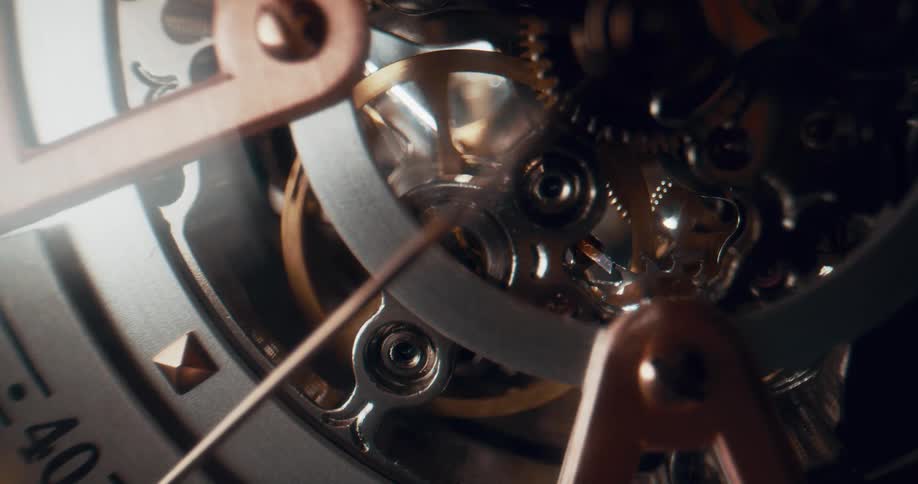 Close up of the moving gears on the functioning mechanism of an analog clock