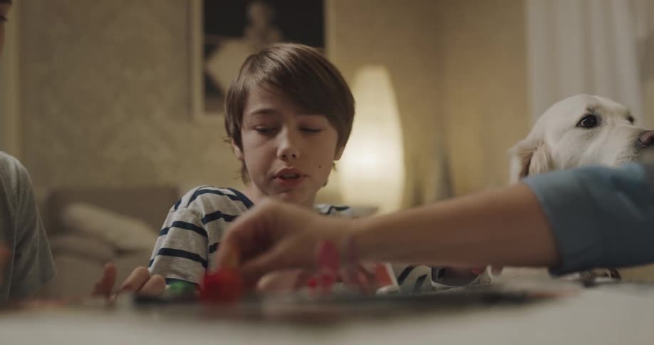 Family is playing a board game together