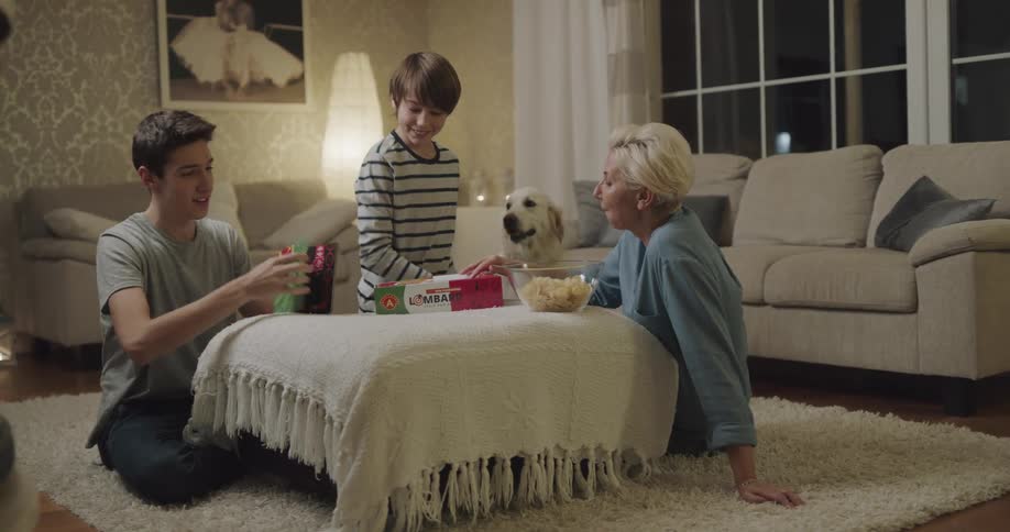 Family is playing a board game at night
