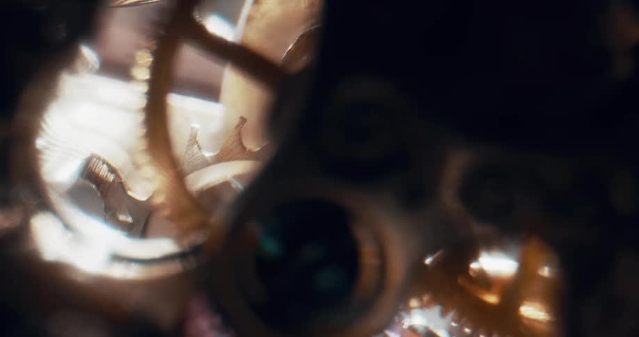 Gears and wheels inside a mechanism are turning