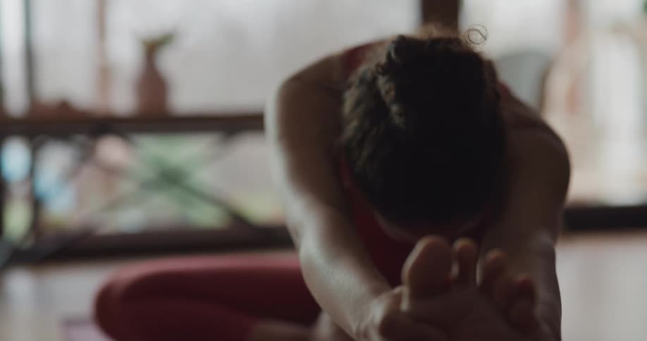 A woman is doing yoga at home