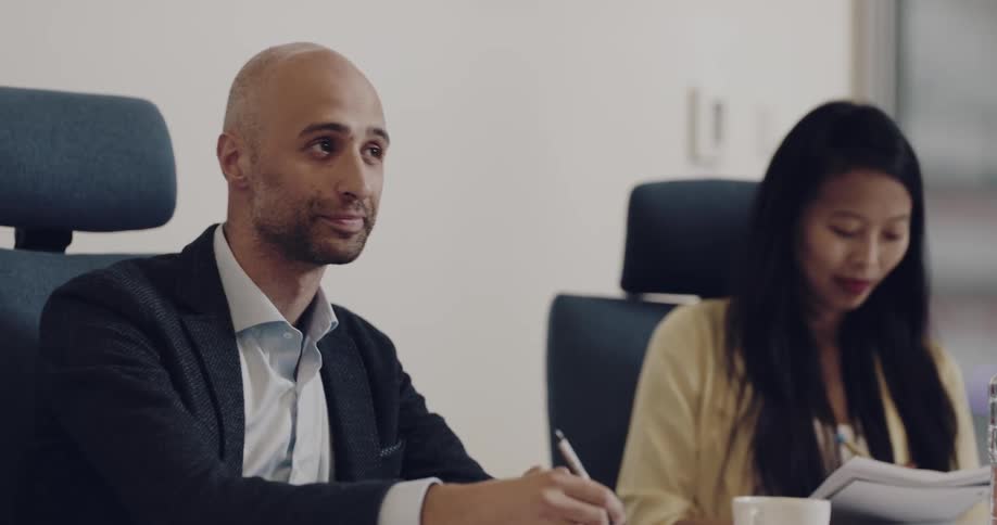 Two people sitting at a desk on a meeting conference room in the office