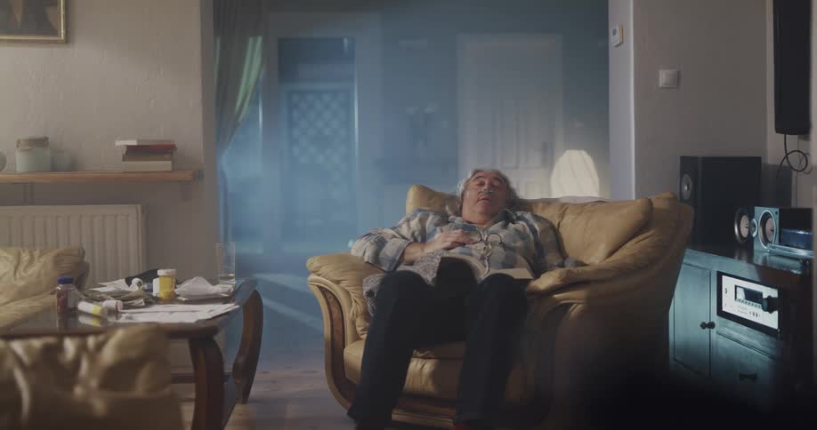 Older man is sitting on a chair