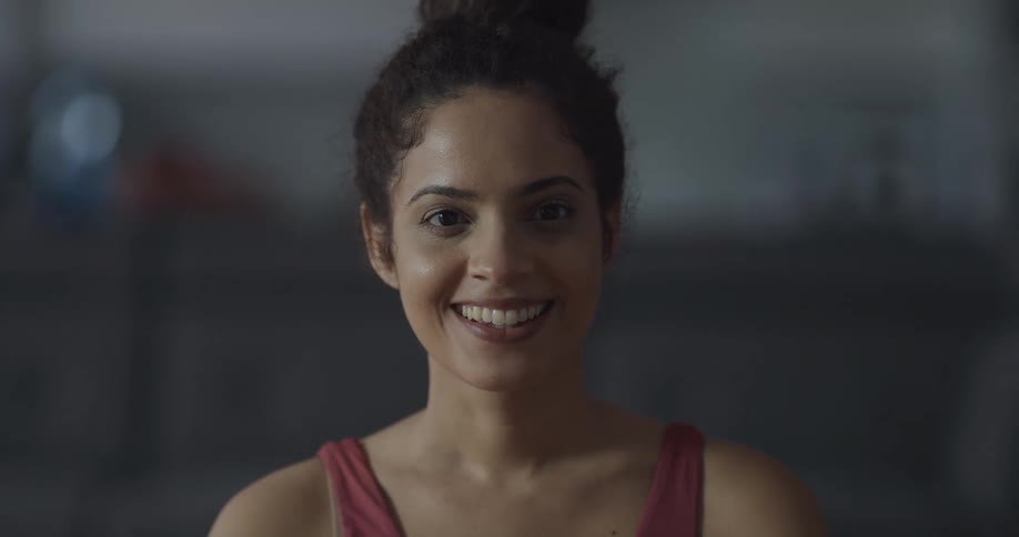 A woman is smiling and looking at the camera