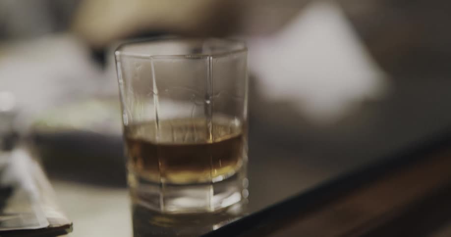A man is pouring himself an alcoholic drink