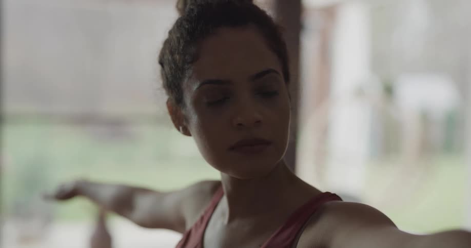 A woman is doing yoga at home