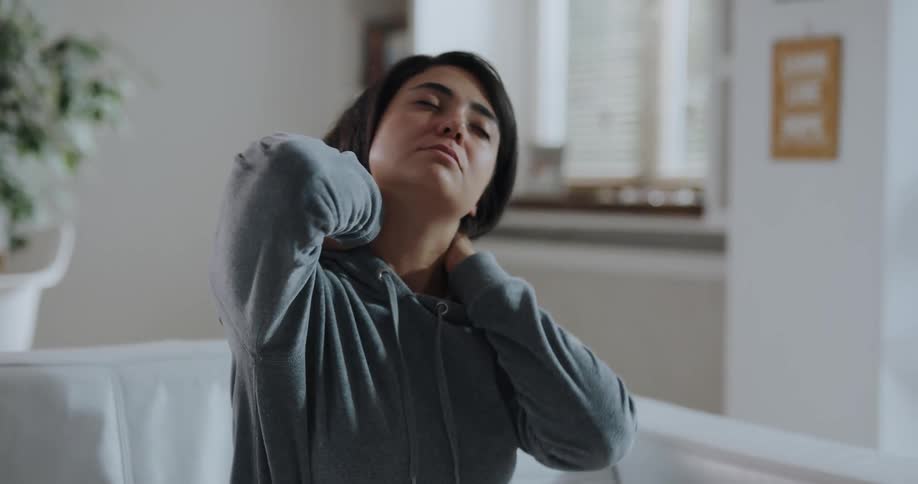 Young woman is stretching on the couch