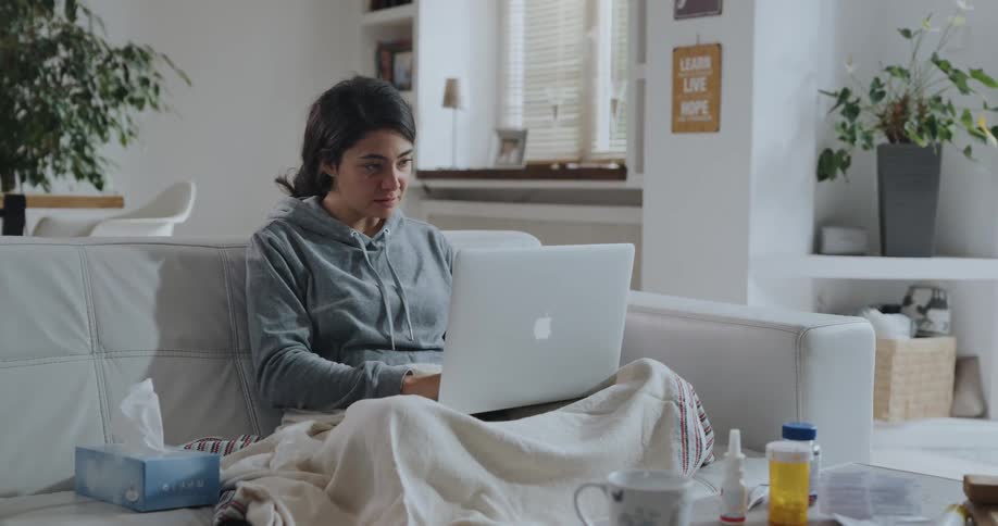 Young women is sitting on the couch