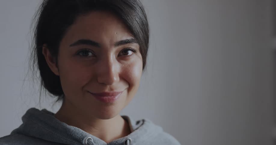 A woman turns her head and smiles