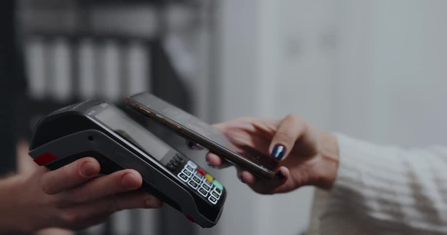 A person scans their phone to pay