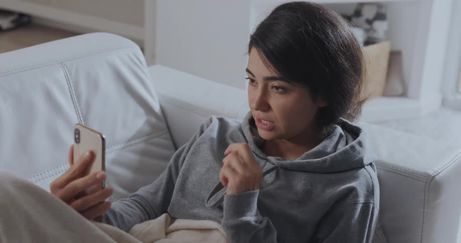 A woman is video chatting on her cell phone